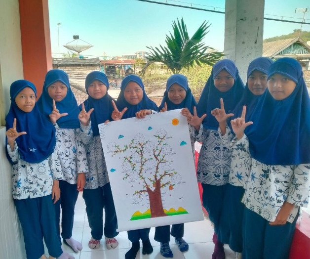 Siswi MIM 16 Karangasem Paciran menampilkan karya. Ini merupakan upaya sekolah untuk tanamkan cinta literasi (Zulfatus Salima/PWMU.CO)