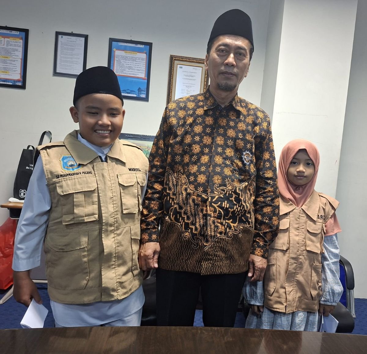 Lazuardy Arkoun Abqaraya dan Siti Hanina Fatimah berfoto setelah mewawancarai Wakil Ketua PWM Jatim, Dr Hidayatulloh, M.Si (Foto: Anang/PWMU.CO)